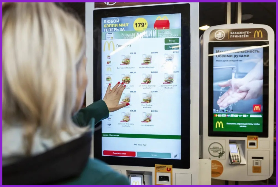 a customer interacting with a McDonald's digital signage